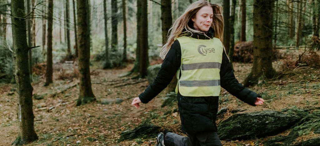 Jente med refleksvest fra Lyse løper i skog