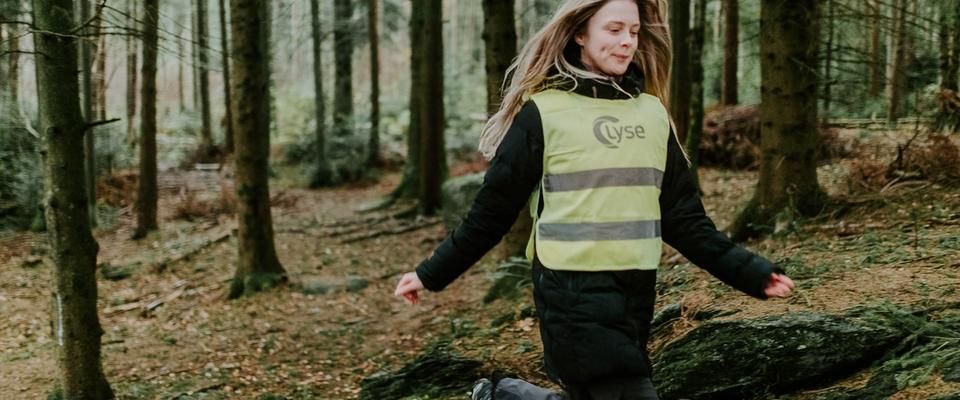 Jente med refleksvest fra Lyse løper i skog